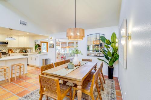 a kitchen and dining room with a wooden table and chairs at Half-Mi to Private Beach Floridana Beach Getaway in Melbourne Beach