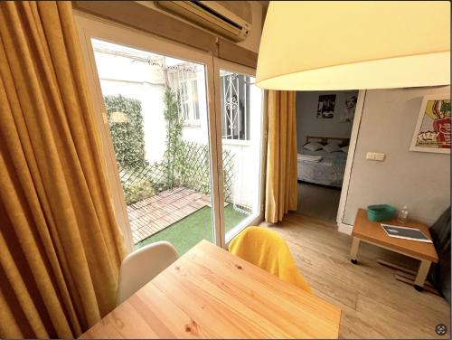 a living room with a table and a large window at Apartamento Plaza de los naranjos in Marbella