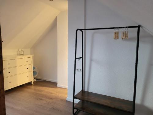 a glass door in a room with a dresser at TinyWohnung im Pott in Castrop-Rauxel