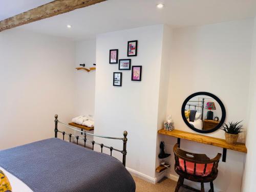 a bedroom with a bed and a mirror at Nine Cooper Lane, Holmfirth in Holmfirth