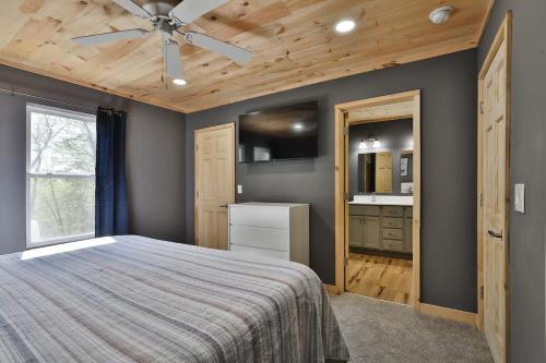 a bedroom with a bed and a ceiling fan at New listing-- Hocking Hills Modern Cabin in Logan