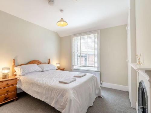 a bedroom with a large bed and a window at Sea View Apartment Near The Beach and Town Center in Cromer