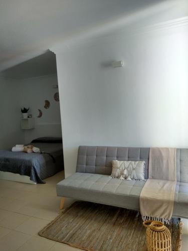 a living room with a couch and a bed at Zen Apartment Tenerife in San Miguel de Abona