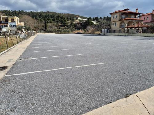 an empty parking lot in front of a house at Vista Luxury Suites in Neos Marmaras