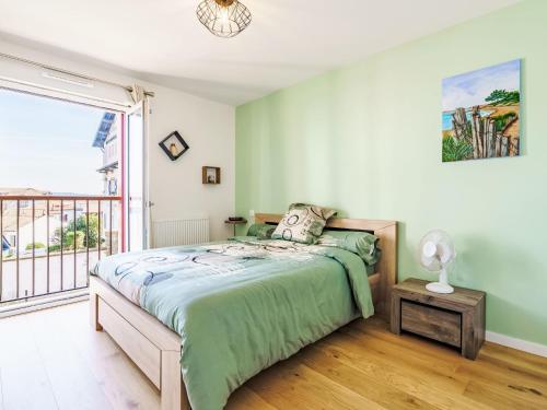 a bedroom with a bed and a balcony at Apartment Bikaleak by Interhome in Ciboure