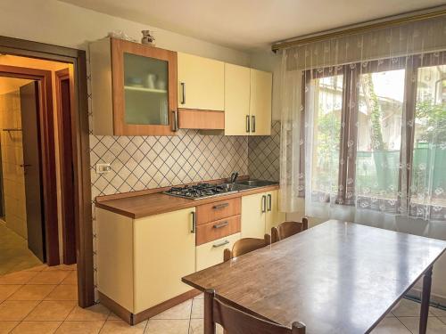a kitchen with a table and a counter top at Apartment Solaris-1 by Interhome in Rosolina Mare