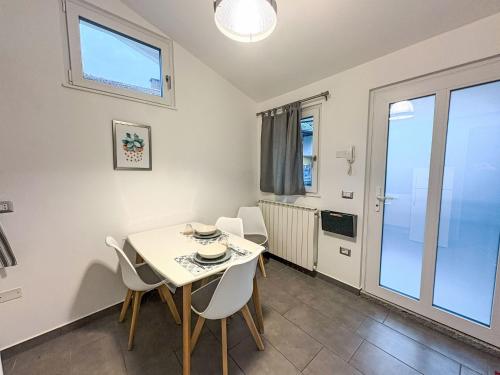 a dining room with a table and chairs and a window at Apartment Casina al Lago by Interhome in Lavena Ponte Tresa