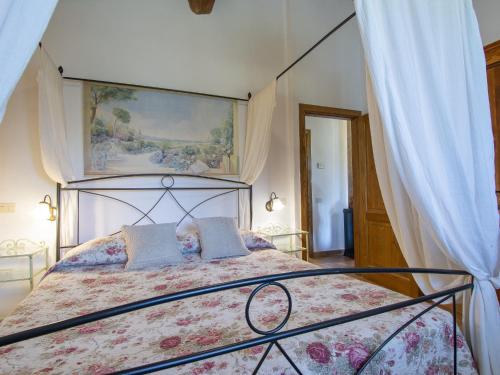 a bedroom with a large bed with a canopy at Holiday Home Il Poderino by Interhome in Londa