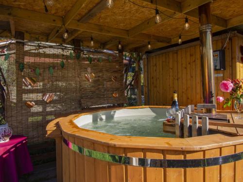 a jacuzzi tub in a room with a table and chairs at Holiday Home Il Poderino by Interhome in Londa