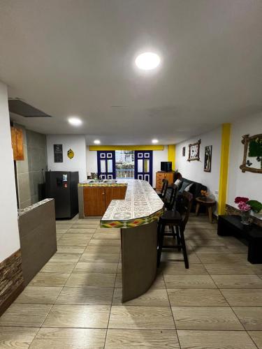 a kitchen and living room with a table in a room at Apartahotel Casa Azul Salento in Salento