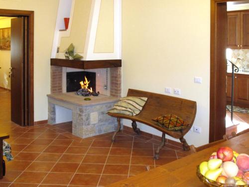 a living room with a fireplace and a bench at Holiday Home Montechioccioli-4 by Interhome in Gaiole in Chianti