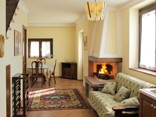 a living room with a couch and a fireplace at Holiday Home Montechioccioli-4 by Interhome in Gaiole in Chianti