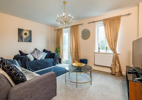 a living room with a couch and a table at Letto Serviced Accommodation -Sleeps 7 - PE7 - FREE Parking in Peterborough