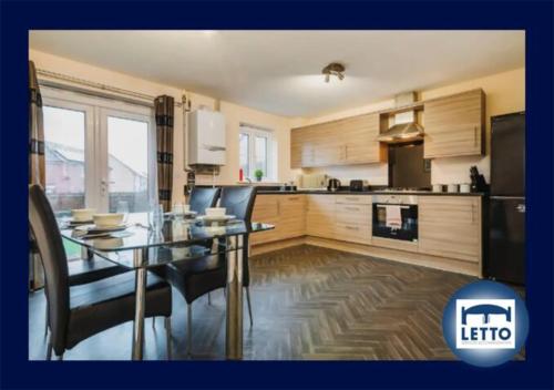 a kitchen and dining room with a glass table and chairs at Letto Serviced Accommodation -Sleeps 7 - PE7 - FREE Parking in Peterborough