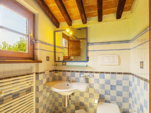 a bathroom with a sink and a toilet and a mirror at Holiday Home I Pioppi - CMA109 by Interhome in Camaiore