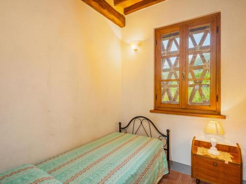 a bedroom with a bed and a window at Holiday Home I Pioppi - CMA109 by Interhome in Camaiore