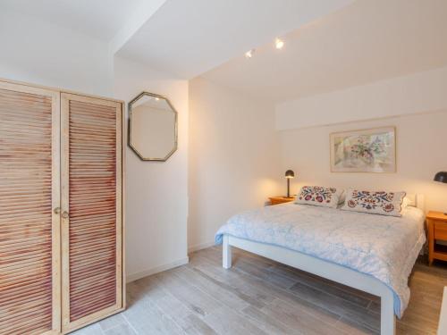 une chambre avec un lit et un miroir dans l'établissement Apartment Terre de Sienne by Interhome, aux Issambres