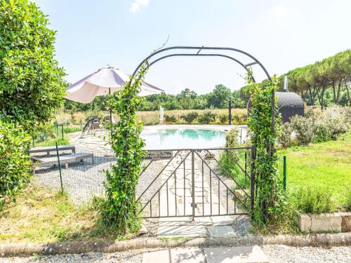 a gate with ivy growing around it next to a pool at Apartment Azalea by Interhome in Spianate