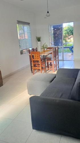 a living room with a table and chairs and a couch at La Pasionaria, casa de descanso en villa El Dique in Rosario de Lerma