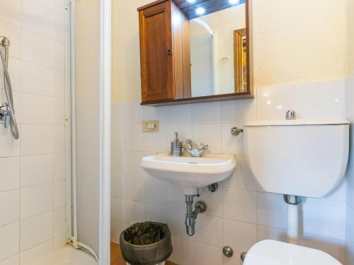 a bathroom with a sink and a toilet and a mirror at Apartment Petralina by Interhome in Lucolena in Chianti