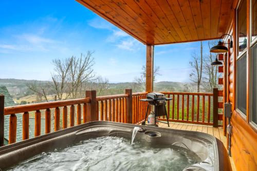 a hot tub on the deck of a house at Sleeps 14 - Indoor Pool, Hot Tub, Arcade Games, Movie Theatre and Pets Welcome in Pigeon Forge