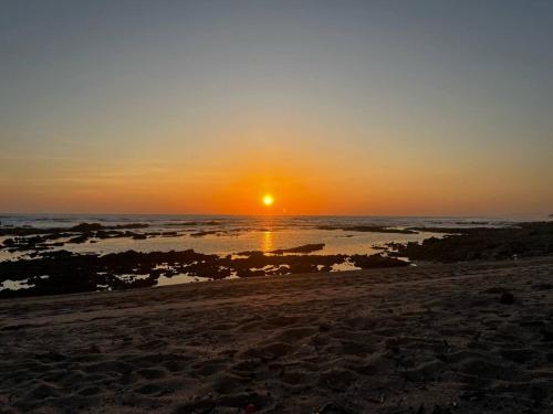 a sunset on the beach with the sun setting at Villas Casa Paz in Cóbano