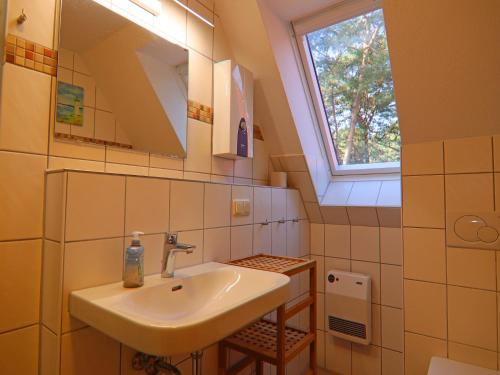 トラッセンハイデにあるReihenhaus Dünenwaldhaus Mitte in Trassenheideの洗面台と窓のあるバスルーム