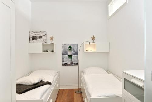 En eller flere senge i et værelse på Penthouse Ostseeresidenz