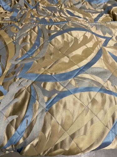 a close up of a bedsheet with a pattern on it at Timber Motel in Clinton