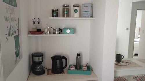 a kitchen with a coffee maker on a shelf at Ameli in Neuquén