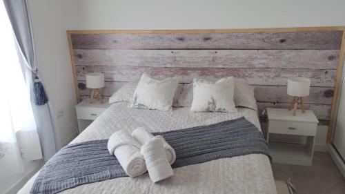 a bedroom with a large bed with two night stands at Ameli in Neuquén
