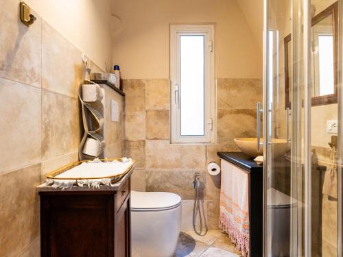 a bathroom with a toilet and a sink at Holiday Home S-Caterina by Interhome in Cervo