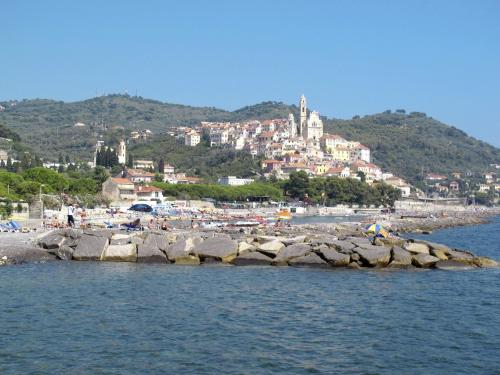 a group of people on a beach near the water at Holiday Home S-Caterina by Interhome in Cervo
