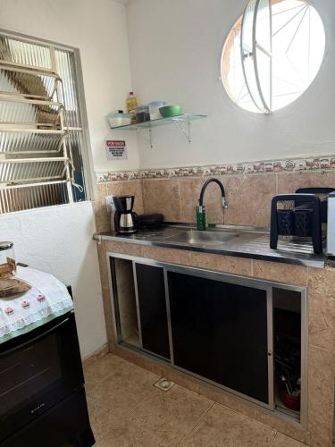 a kitchen with a sink and a counter top at Recanto da Serra in Miguel Pereira