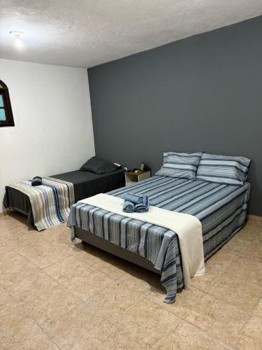 a bedroom with two beds in a room at Recanto da Serra in Miguel Pereira