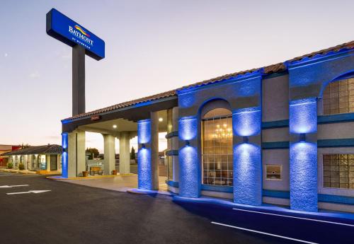 a blue building with a street sign in front of it at Baymont by Wyndham Kingman in Kingman
