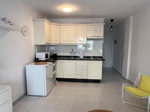 a kitchen with white cabinets and a white refrigerator at 222 Puerto de la Cruz in Puerto de la Cruz