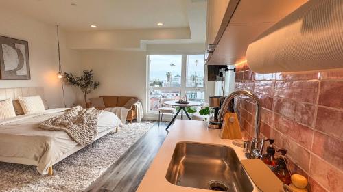 a kitchen with a sink and a bed in a room at Lovely Studio in heart of Hollywood in Los Angeles