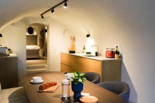 a kitchen and dining room with a table and a room with a bed at Domnacht aan de gracht in Utrecht