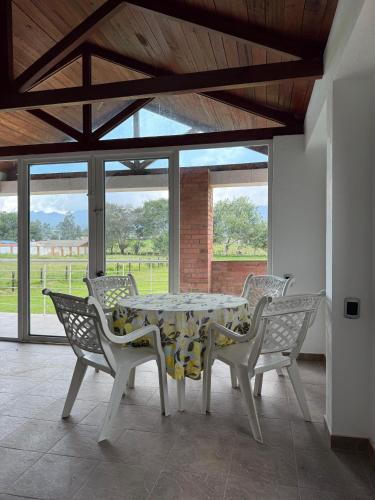 a dining room with a table and chairs at Casa campestre familiar in Guasca