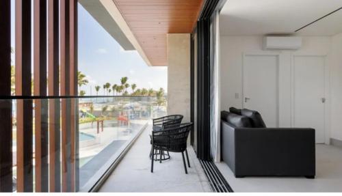 a living room with a couch and a balcony with a view at GAV Porto Alto Resorts in Ipojuca