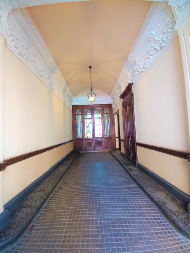 an empty hallway of a building with a door at Dorolea Rooms Torino Centro in Turin