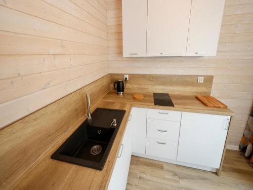 a kitchen with white cabinets and a sink at House in Stepnica near Szczecin Lagoon in Stepnica