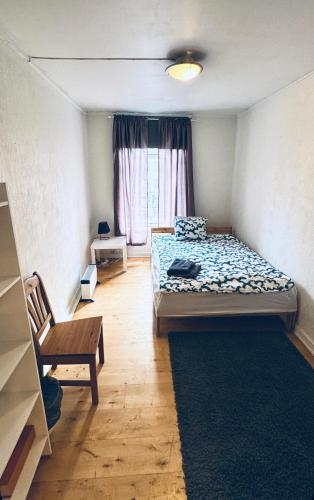 a bedroom with a bed and a table and a window at RELAXED LIVING No 02 Historic Oslo in Oslo