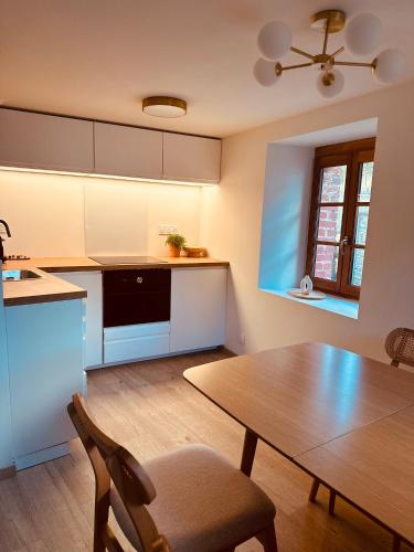 a kitchen with a table and a dining room at La Maison de Victoire et Alix in Pontrieux