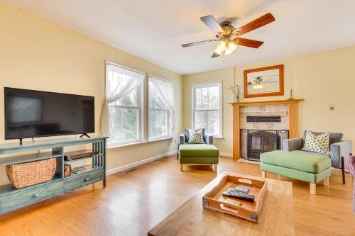 a living room with a flat screen tv and a fireplace at Family Home with Game Room and Decks in Etlan! in Etlan