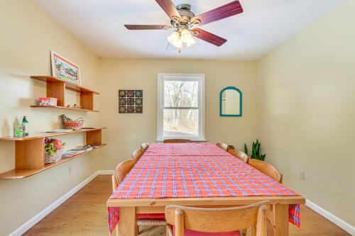 a dining room with a table and a ceiling fan at Family Home with Game Room and Decks in Etlan! in Etlan