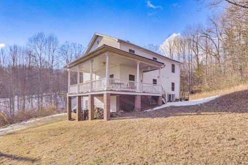 a large house with a porch on a field at Family Home with Game Room and Decks in Etlan! in Etlan