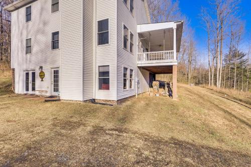 a large white house with a balcony on a yard at Family Home with Game Room and Decks in Etlan! in Etlan