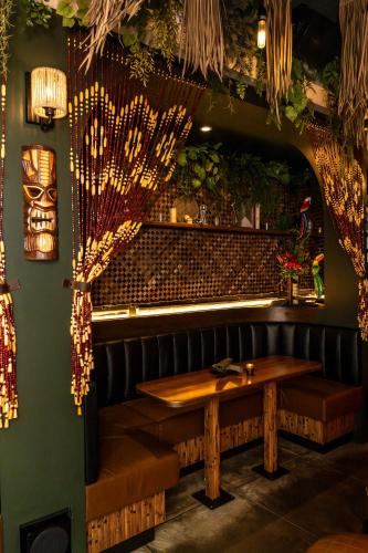 a dining room with a wooden table and benches at The Brick Boutique Hotel in Oceanside